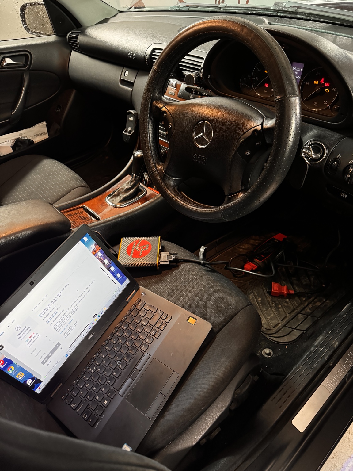 Laptop and KP tuning interface connected inside a Mercedes-Benz