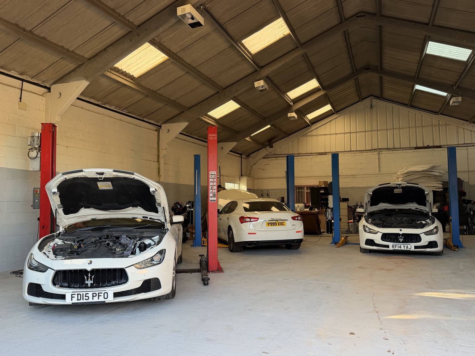 Three Maserati cars inside the KP Car Care workshop